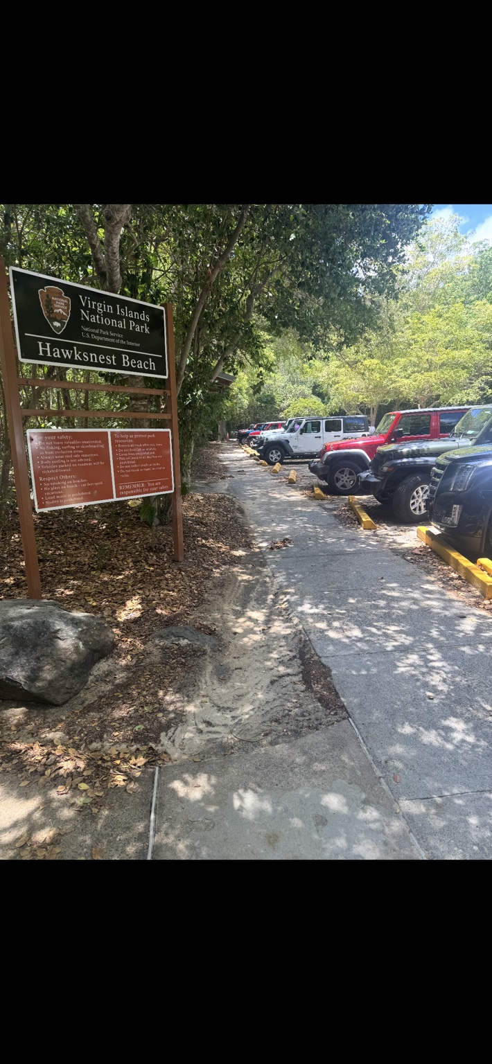 Hawksnest Beach entrance sign and parking area in Virgin Islands National Park