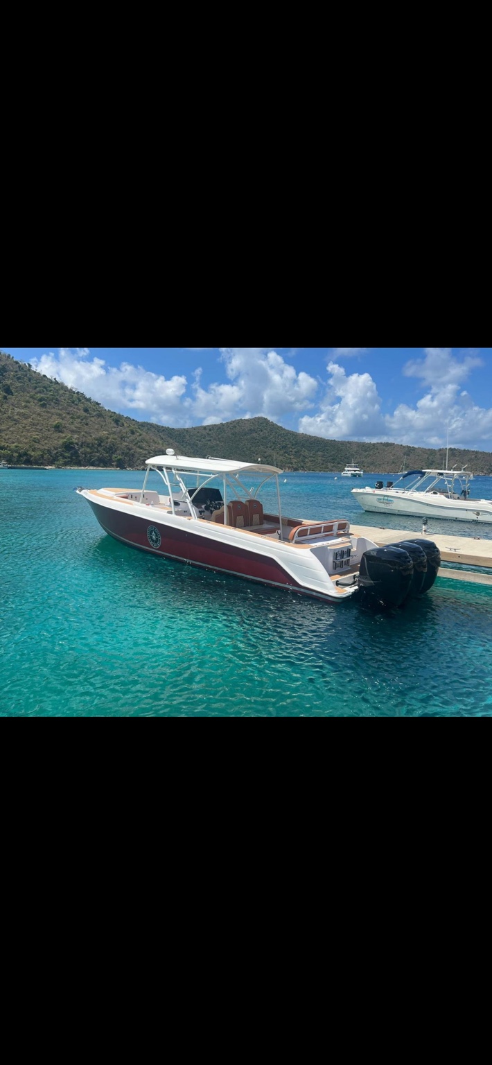 Private charter boat floating in clear turquoise water