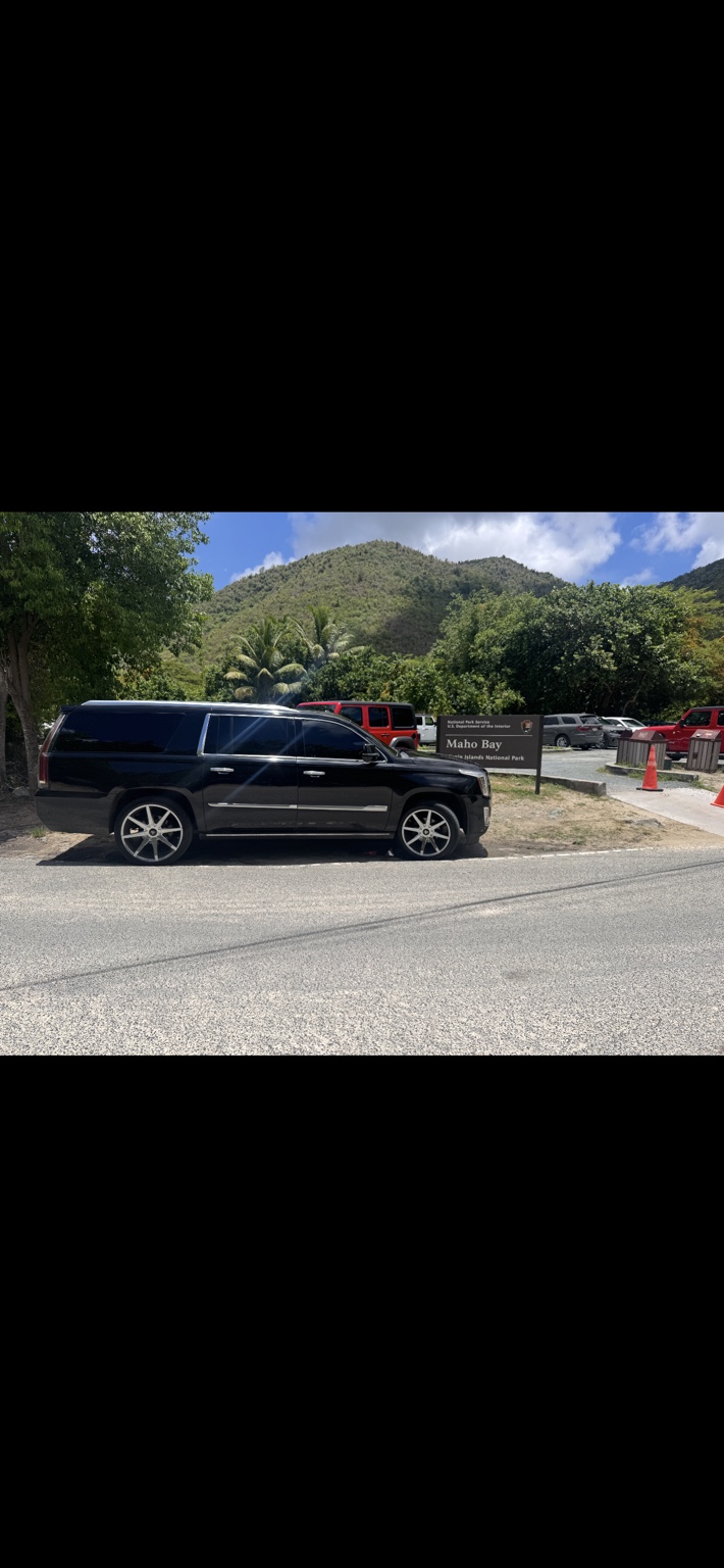 Black VI 2 THE BONE SUV near the Maho Bay entrance sign on St. John